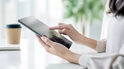 User submitting online form on tablet